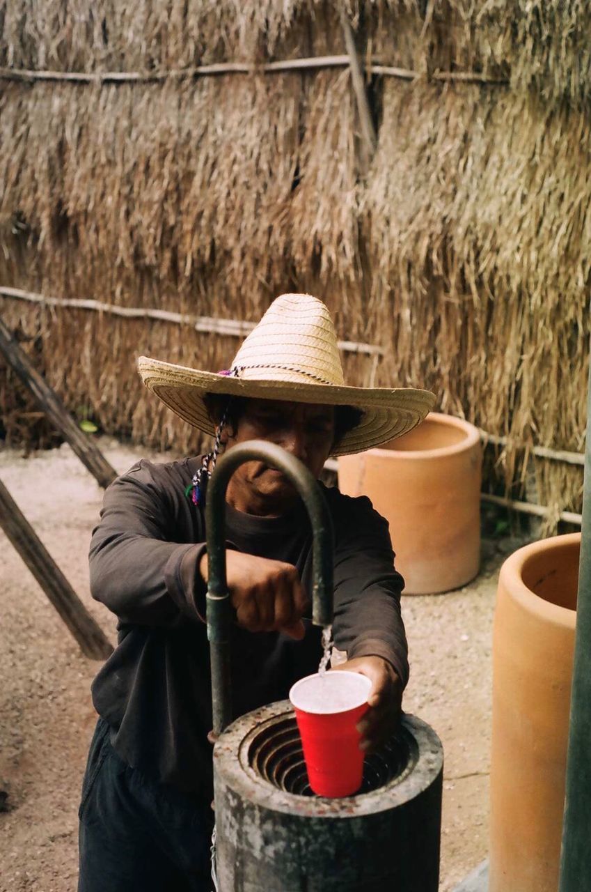 MIDSECTION OF MAN WORKING IN TRADITIONAL CLOTHING