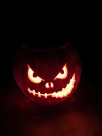 Close-up of illuminated pumpkin against black background