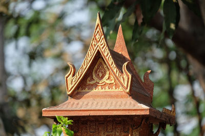 Low angle view of temple against trees