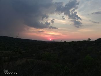 Scenic view of field against sky during sunset