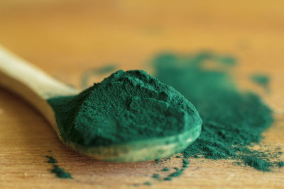 Spirulina powder on a wooden background