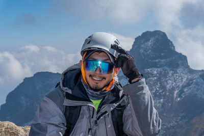 Portrait of man standing against mountain