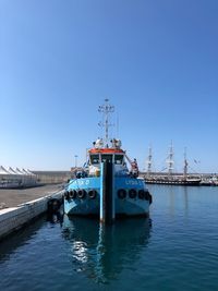 Pier over sea against clear blue sky