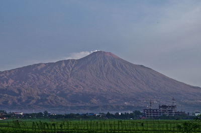 Scenic view of landscape against cloudy sky