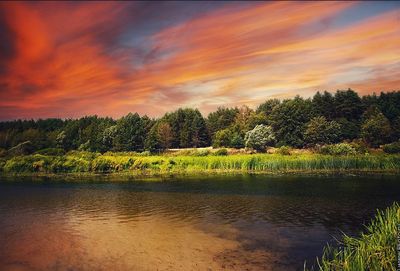 Scenic view of lake against orange sky