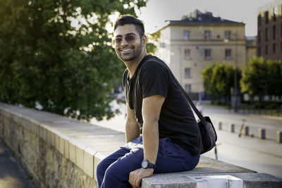 Portrait of young man sitting outdoors