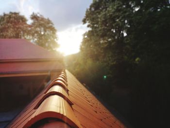 Tilt image of car against sky during sunset