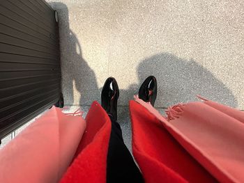 Low section of woman standing on street