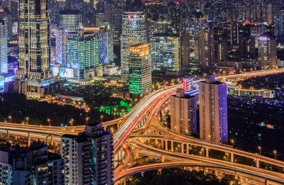 High angle view of bridges amidst illuminated cityscape