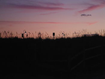 Silhouette landscape against sky during sunset