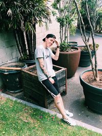 Portrait of young man standing in yard