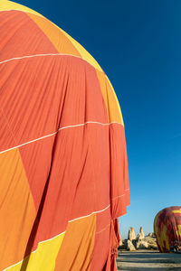 Low angle view of hot air balloon against clear blue sky