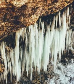 Panoramic shot of icicles on rock formation