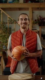 Portrait of smiling young man holding food