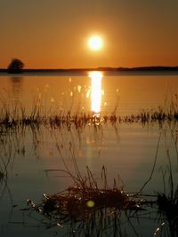 Scenic view of lake against sky during sunset