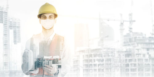 Digital composite image of man working at cityscape