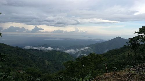 Scenic view of mountains against cloudy sky