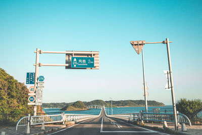 Road sign against clear sky