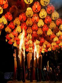 Low angle view of illuminated lanterns hanging at night