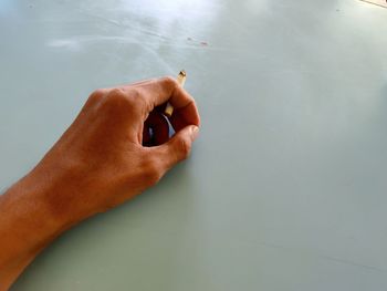 Midsection of person smoking cigarette