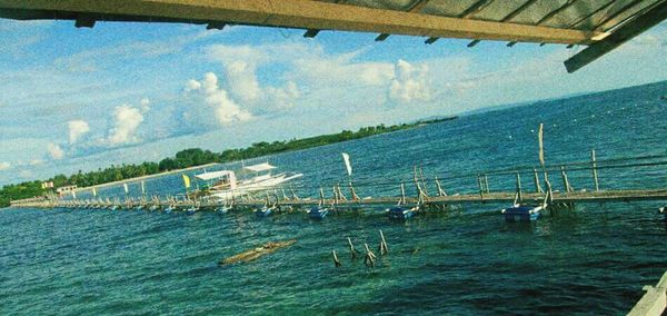 Boats in sea against clear sky