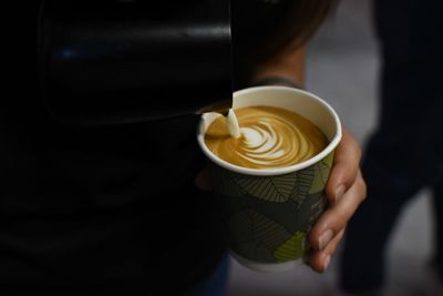 Woman holding coffee cup