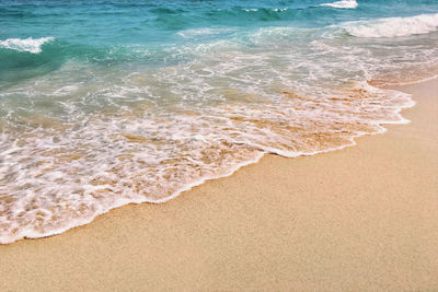 High angle view of waves rushing towards shore