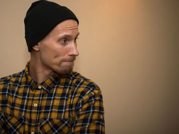Portrait of young man against white background