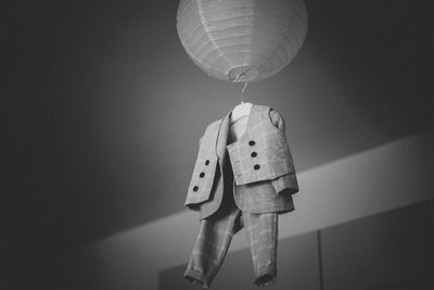 Low angle view of lanterns hanging on wall at home