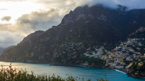 Scenic view of sea and mountains against sky