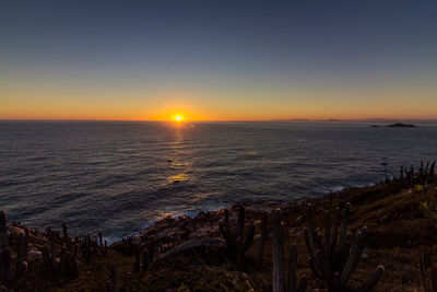 Scenic view of sea against clear sky during sunset