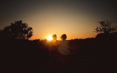 Silhouette of people at sunset