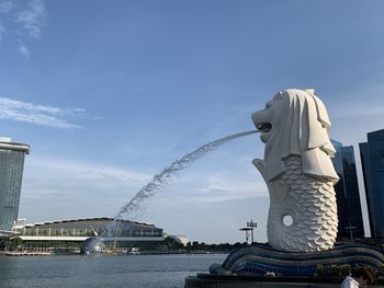 Statue of buildings against cloudy sky