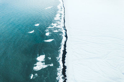 High angle view of frozen water on land