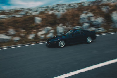 Close-up of car on road