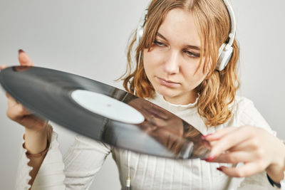 Woman playing music from vinyl record. analog record. retro and vintage style. analog sound. music