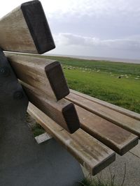 Cross on grass against sky