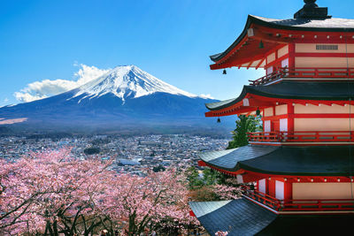 Panoramic view of buildings and mountains against sky