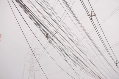 Low angle view of electricity pylon against sky