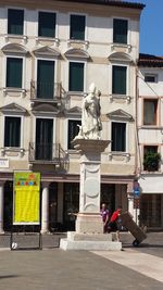 Low angle view of statue in front of building