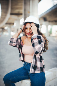 Portrait of smiling young woman standing outdoors