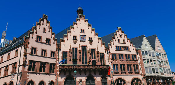 Low angle view of buildings against blue sky