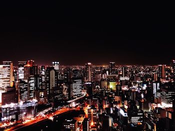 High angle view of illuminated buildings in city at night