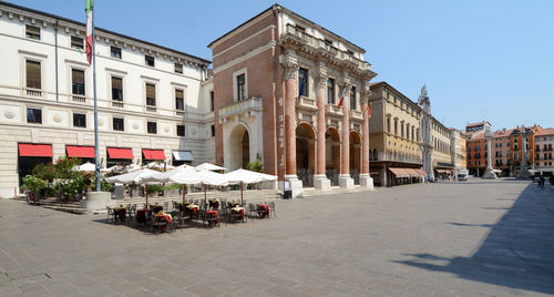 Group of people on street amidst buildings in city