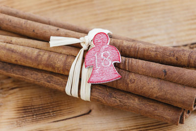 Bundle of cinnamon sticks with star shape tag on table