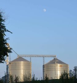 Low angle view of buildings against clear blue sky