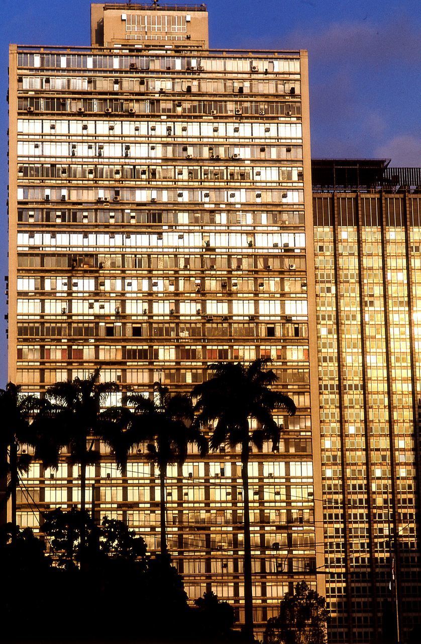 LOW ANGLE VIEW OF ILLUMINATED BUILDINGS AGAINST CLEAR SKY