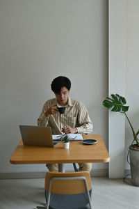 Man sitting on table at home