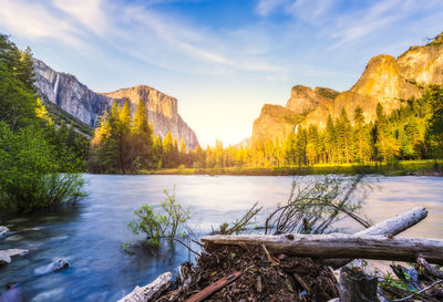 Scenic view of lake by mountains against sky