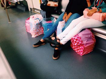 Low section of women sitting
